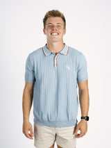 Light blue Georgia Southern men's ribbed polo shirt by Arena Graffiti with a "GS" logo, displayed on a mannequin.