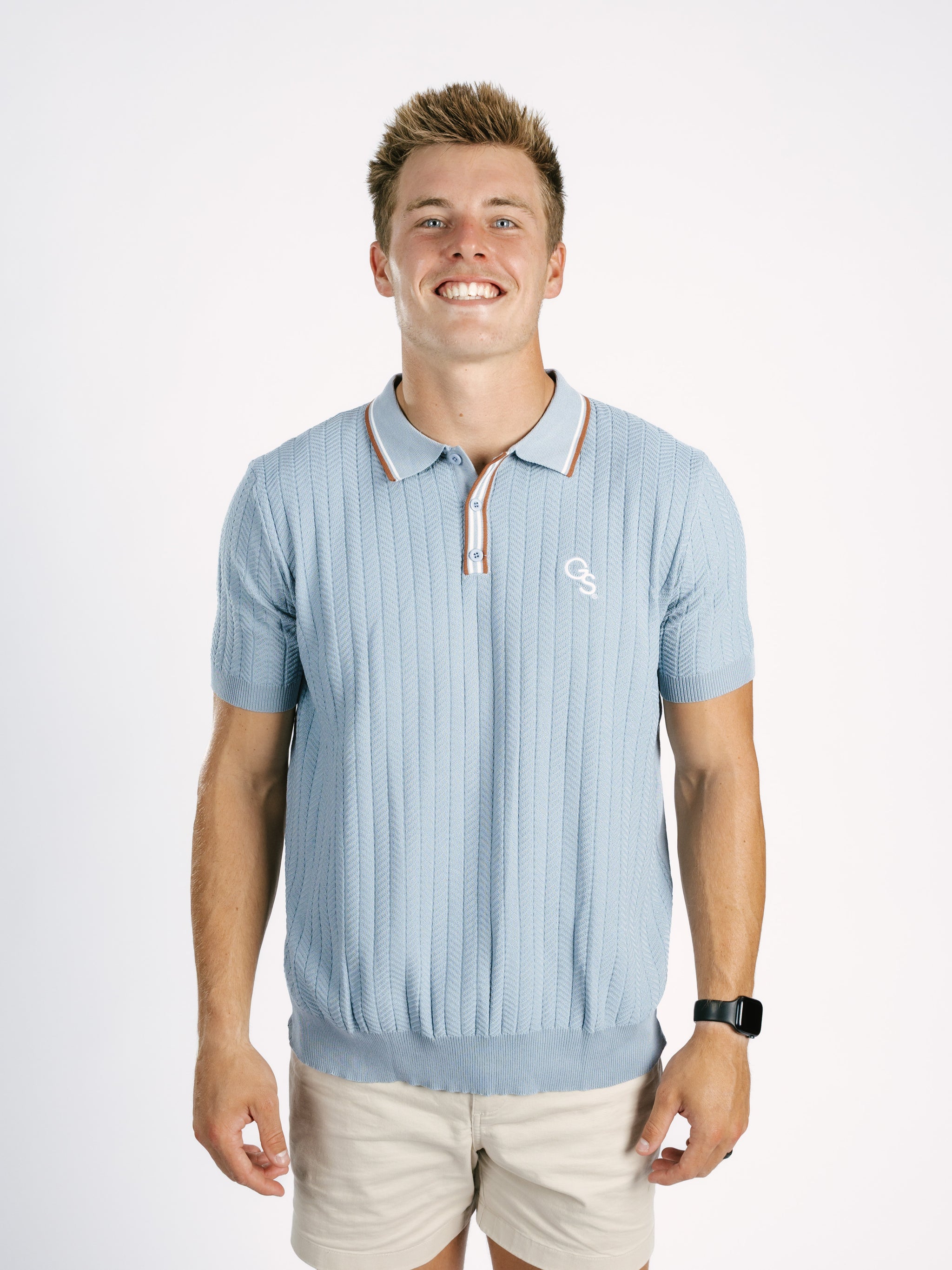 Light blue Georgia Southern men's ribbed polo shirt by Arena Graffiti with a "GS" logo, displayed on a mannequin.