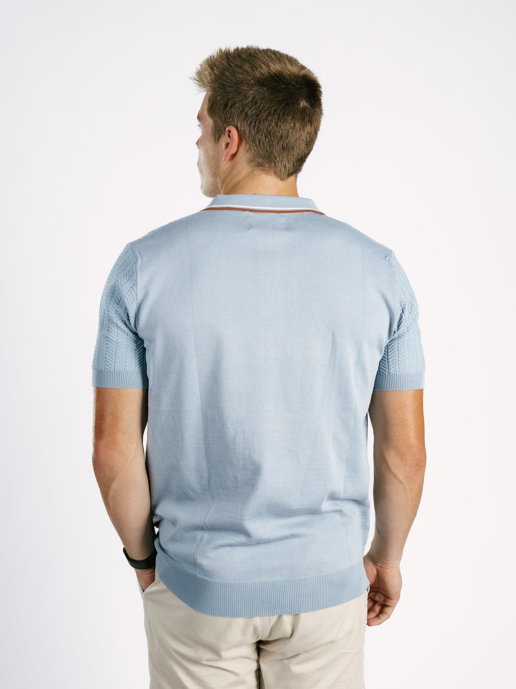 Light blue Georgia Southern men's ribbed polo shirt by Arena Graffiti, featuring the "GS" logo on the chest.