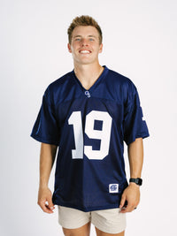 Georgia Southern men's navy jersey by Arena Graffiti with "JD" lettering, displayed on a hanger with a plain background.