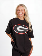 UGA Bulldogs women's "Oval Mark" tee by Arena Graffiti showing a casual fit with team logo and graphic design on front.