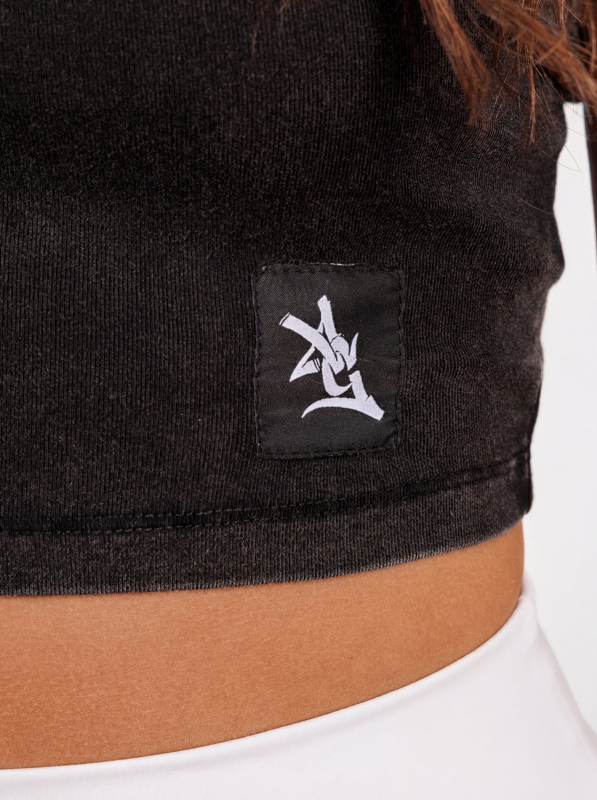 UGA Bulldogs women's "Oval G Bulldogs" crop top by Arena Graffiti, featuring team logo and stylish design on a black fabric background.